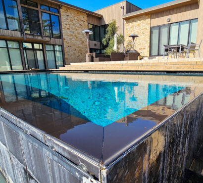 Glass tile infinity edge pool waterfall wall