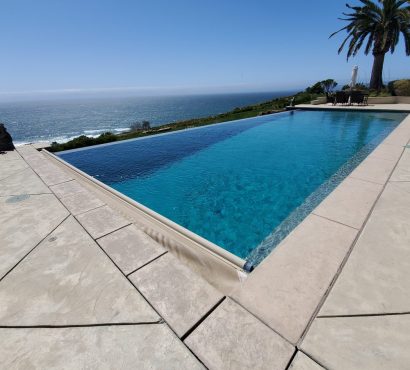 Oceanfront infinity pool cover retracting