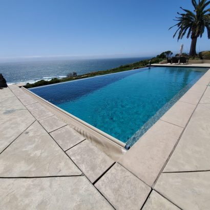 Oceanfront infinity pool cover retracting
