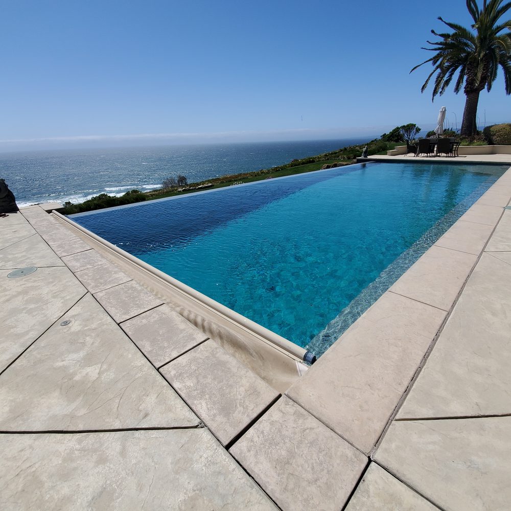 Oceanfront infinity pool cover retracting