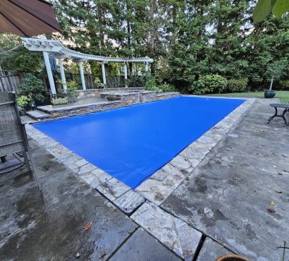 Royal blue pool cover stone patio pergola