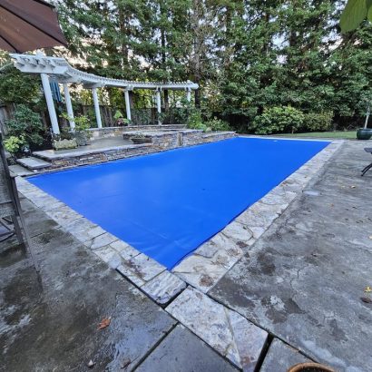 Royal blue pool cover stone patio pergola