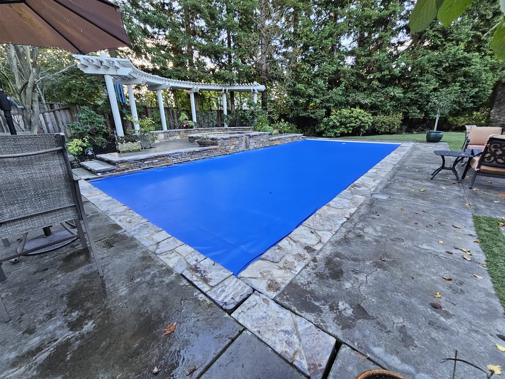 Royal blue pool cover stone patio pergola